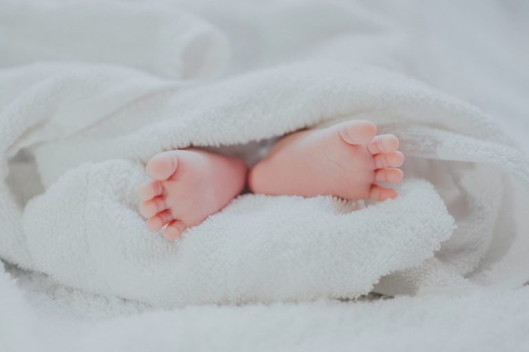 a baby's feet on a blanket