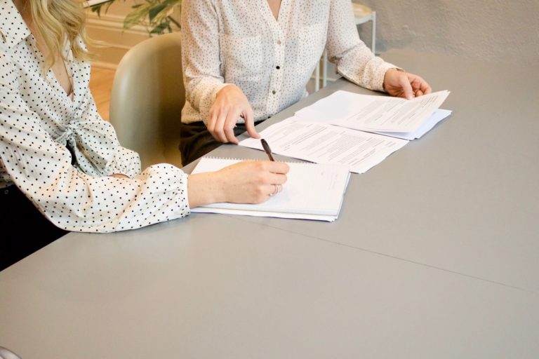 a person writing on a piece of paper