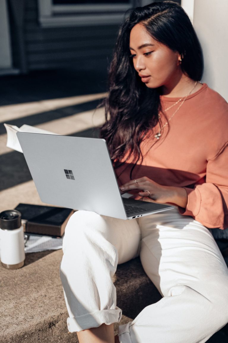 a person sitting on the floor using a laptop