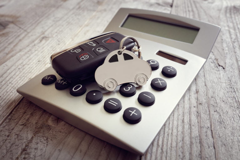 Car shape keyring and key on calculator