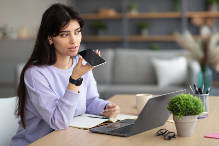 Woman using voice search assistant on smart phone